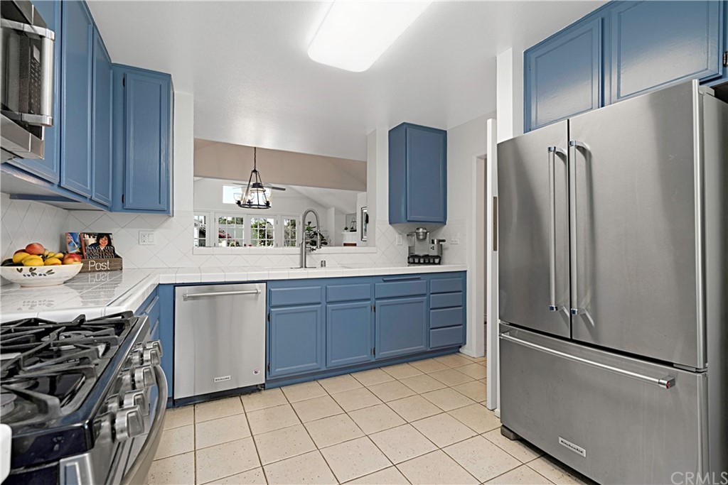 809 Canyon Wash Drive Pasadena, CA 91107 - Photo 8 of 17 a kitchen with a refrigerator sink and cabinets
