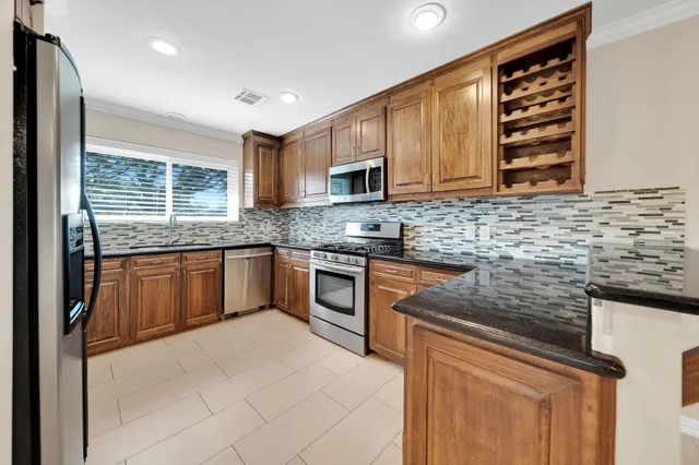 a view of a kitchen with a sink and a window