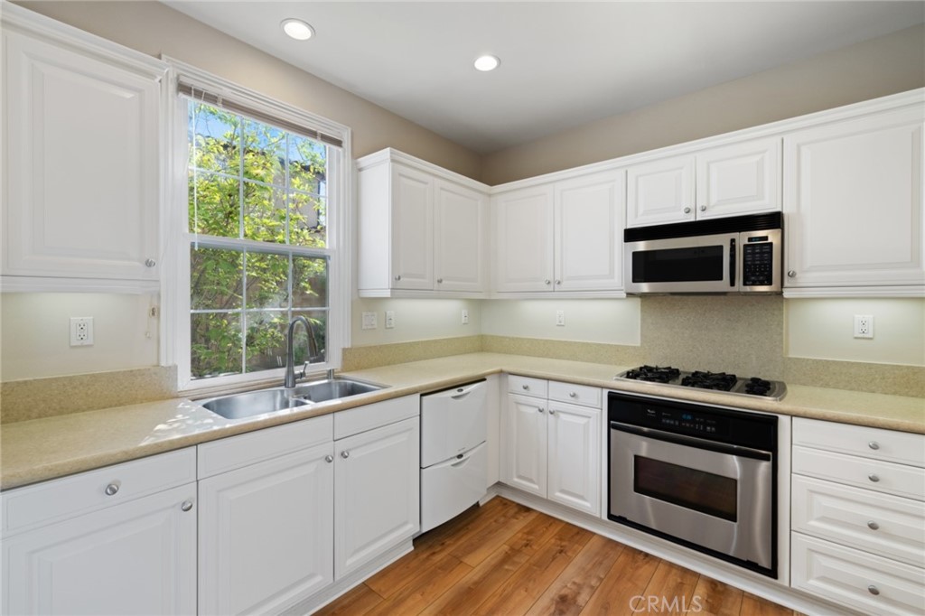 119 White Flower Irvine, CA 92603 - Photo 13 of 38 a kitchen with a sink stove and microwave