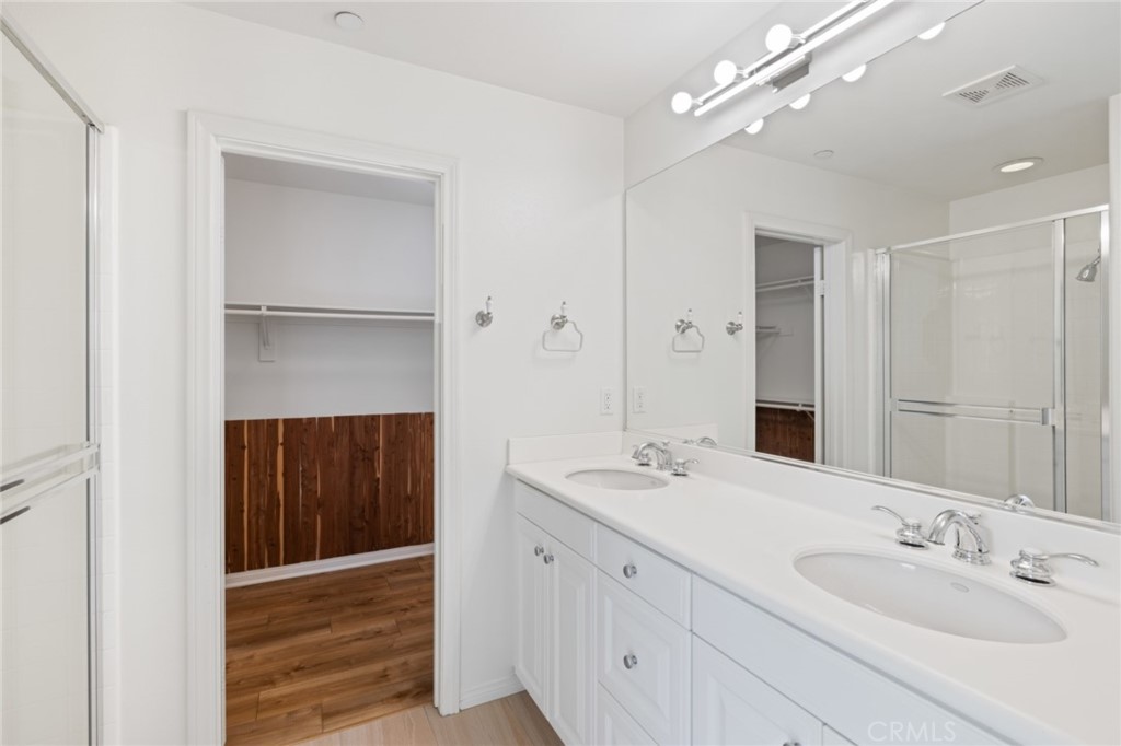 119 White Flower Irvine, CA 92603 - Photo 17 of 38 a spacious bathroom with a double vanity sink a large mirror and shower