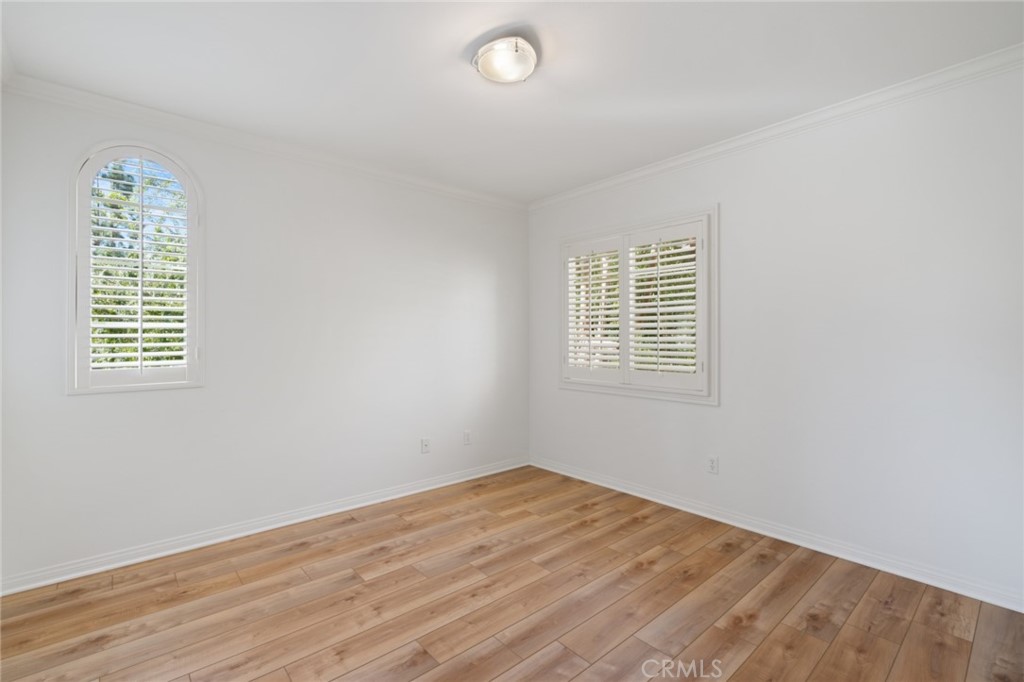 119 White Flower Irvine, CA 92603 - Photo 18 of 38 an empty room with wooden floor and windows