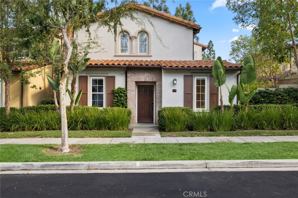 119 White Flower Irvine, CA 92603 - Photo 2 of 38 a front view of a house with a yard and garage