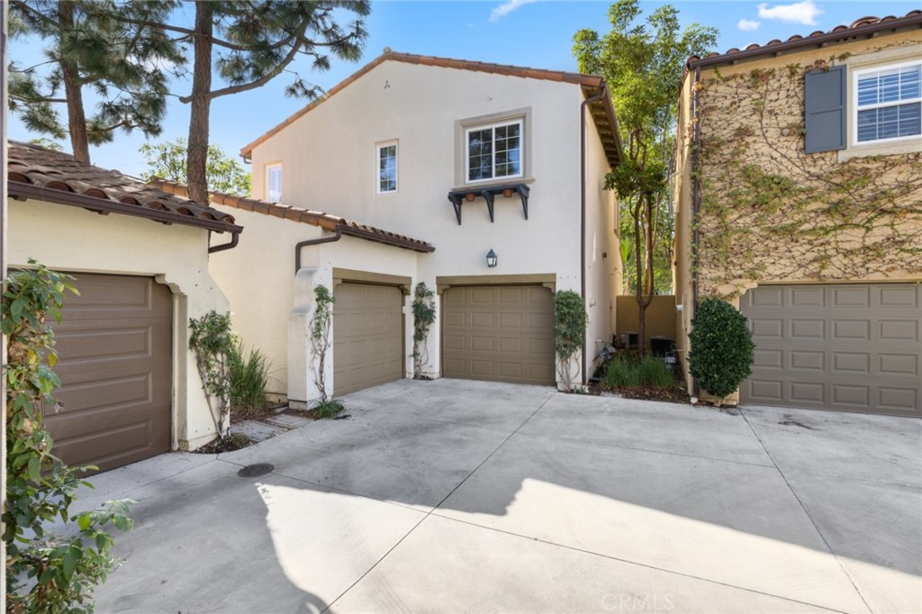 119 White Flower Irvine, CA 92603 - Photo 21 of 38 a view of a white house with a outdoor space and a garage
