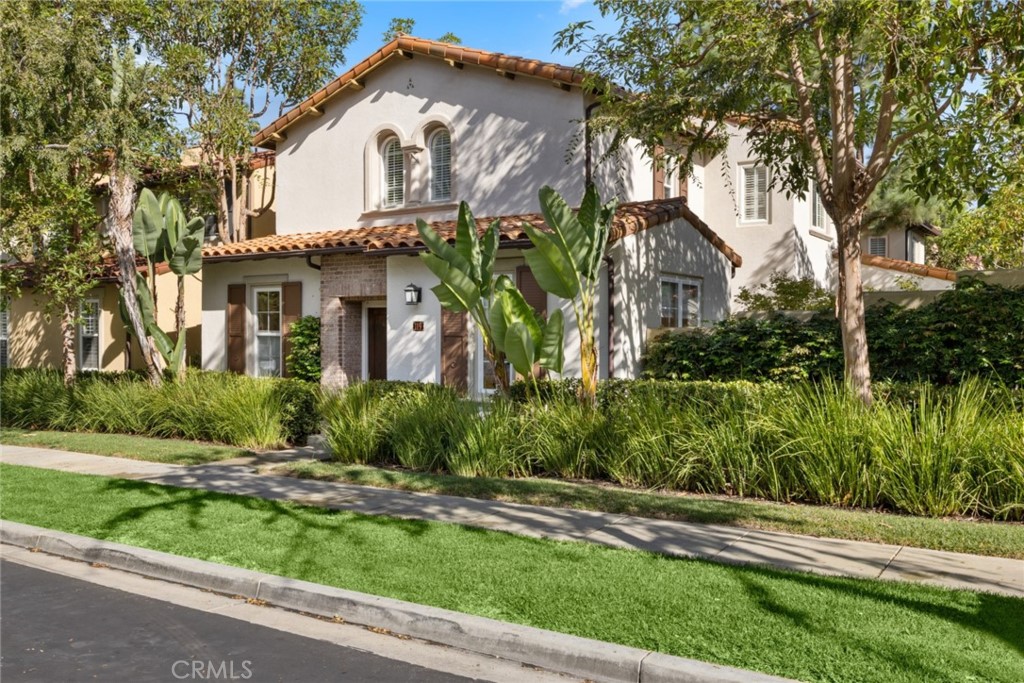 119 White Flower Irvine, CA 92603 - Photo 3 of 38 a front view of house with yard and green space