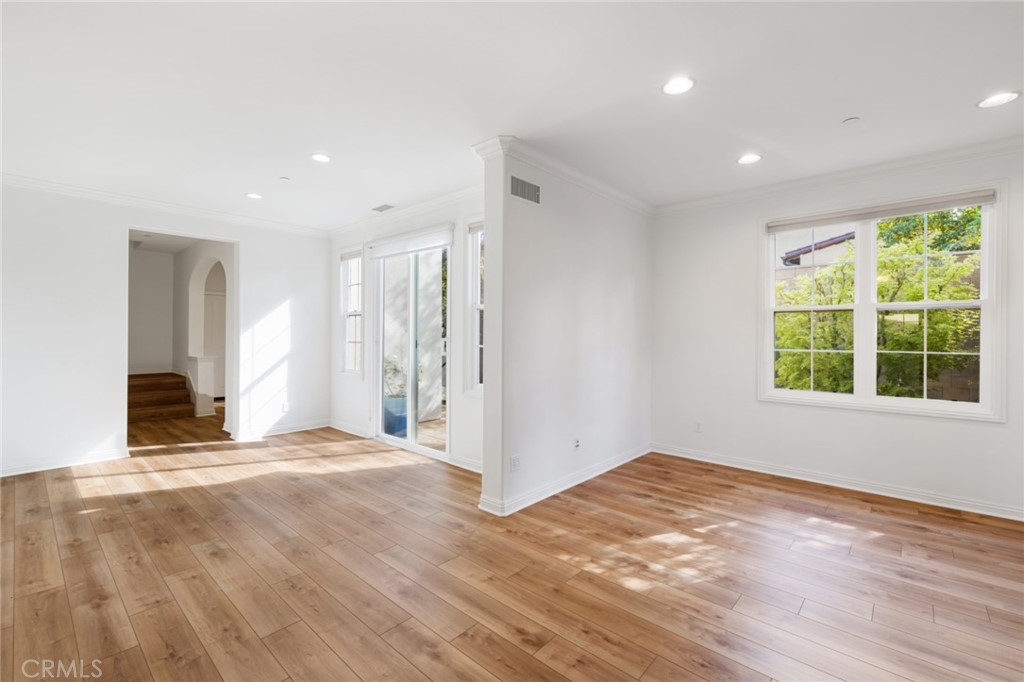 119 White Flower Irvine, CA 92603 - Photo 5 of 38 a view of an empty room with wooden floor and a window