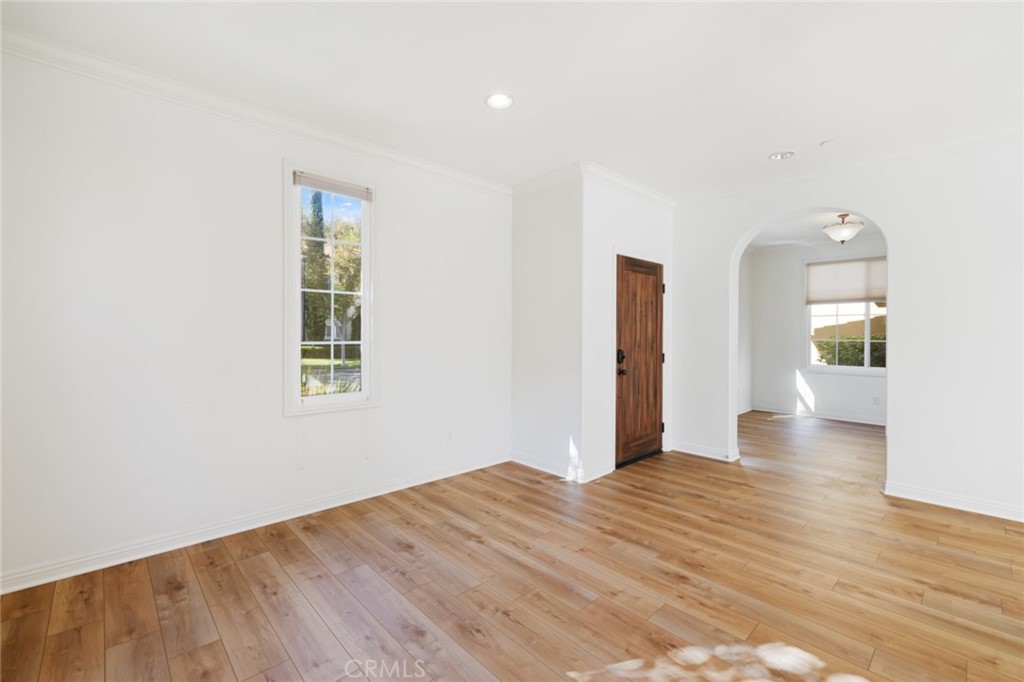 119 White Flower Irvine, CA 92603 - Photo 7 of 38 a view of an empty room with wooden floor and a window