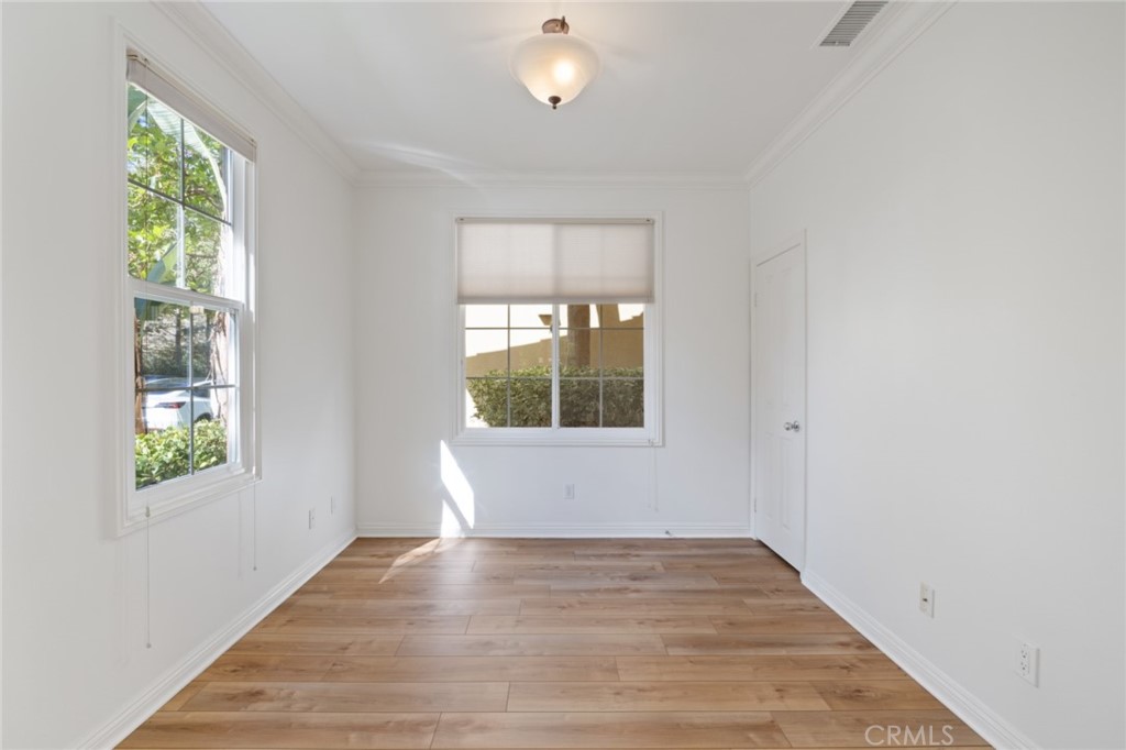 119 White Flower Irvine, CA 92603 - Photo 9 of 38 a view of an empty room with wooden floor and a window