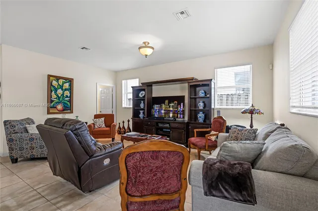 a kitchen with stainless steel appliances granite countertop a stove top oven a refrigerator a sink and dishwasher