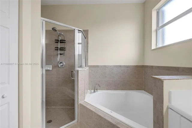 a en suite bathroom with a double vanity sink and a mirror