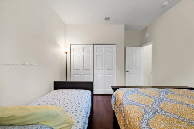 a bedroom with bed and wooden floor