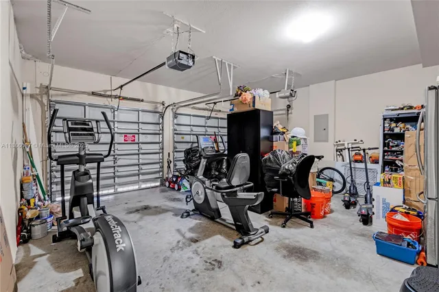 a view of a patio with a table and chairs under an umbrella