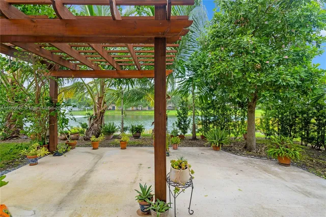 a view of a patio with a table and chairs under an umbrella