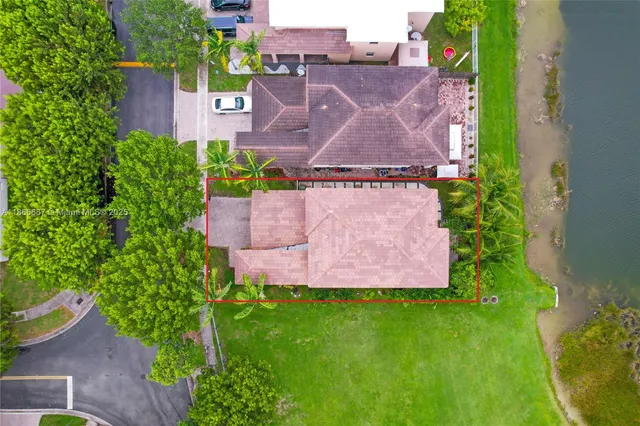an aerial view of a house with a garden and a yard