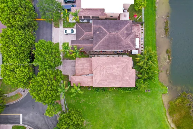 an aerial view of a house with a garden and a yard