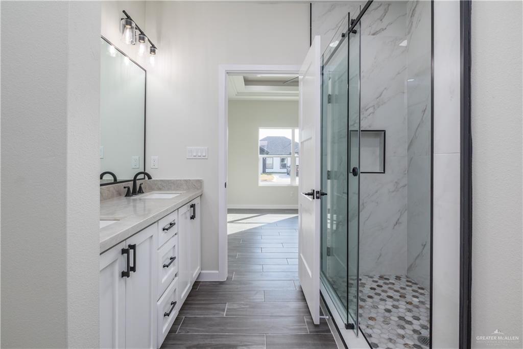3559 Satelite Street Edinburg, TX 78542 - Photo 10 of 22 a bathroom with a double vanity sink a toilet and shower