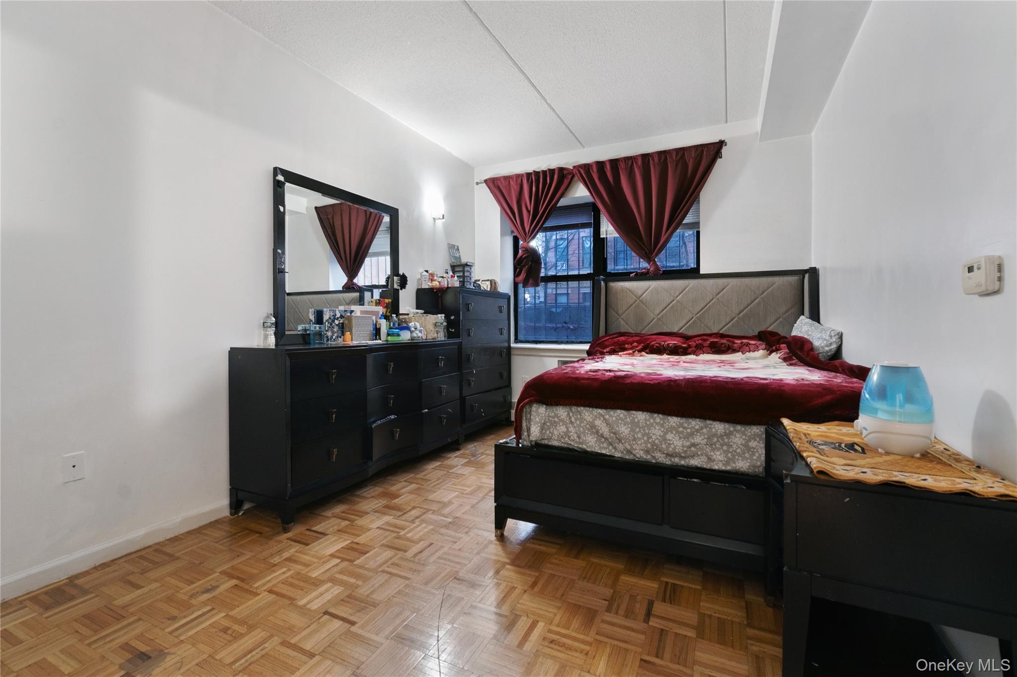 566 Gates Avenue, Unit 1B Brooklyn, NY 11221 - Photo 5 of 9 a bedroom with a bed and wooden floor