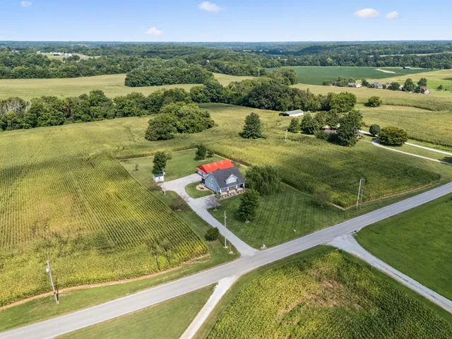 a spacious bedroom with a large bed and a chandelier