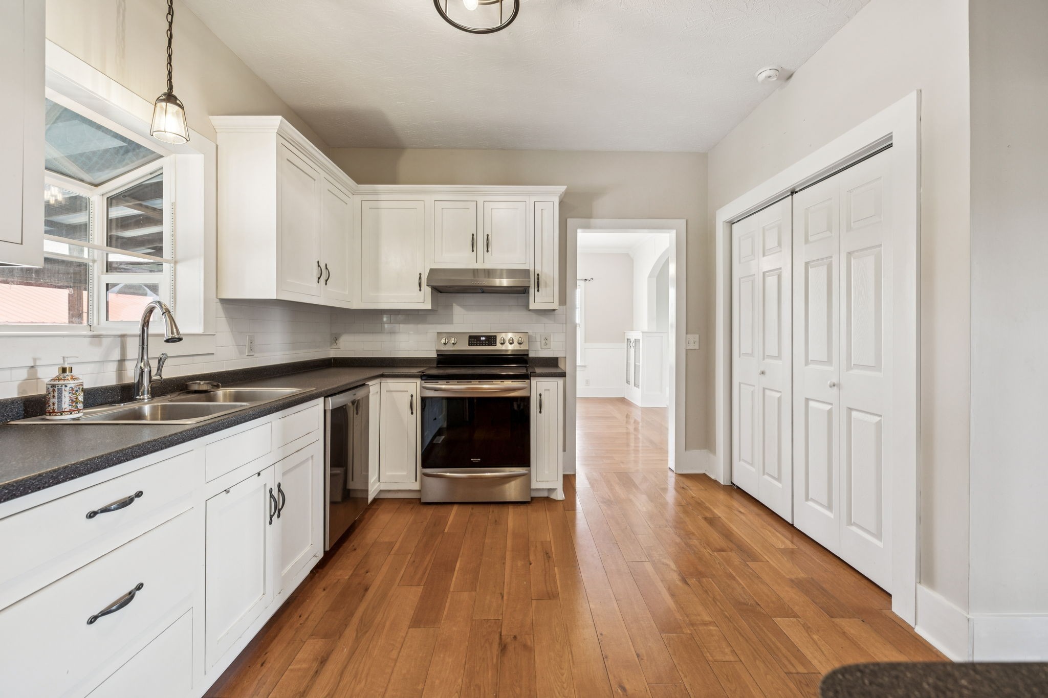 572 Buntin Mill Road Cottontown, TN 37048 - Photo 30 of 67 a kitchen with granite countertop a sink cabinets and stainless steel appliances