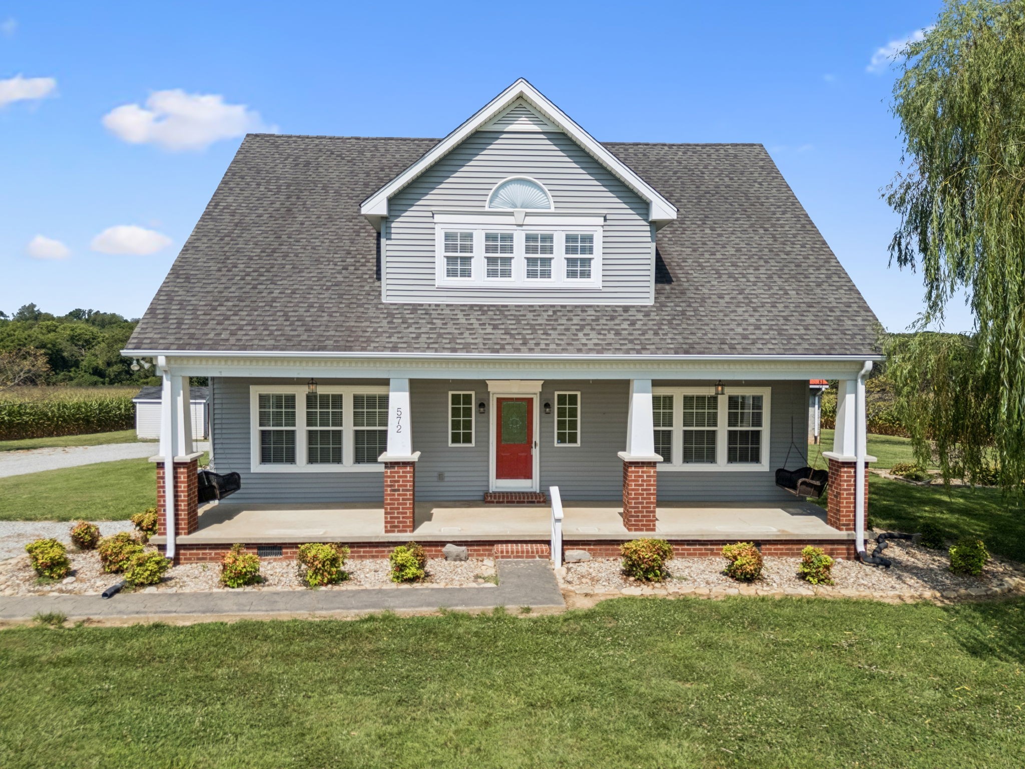 572 Buntin Mill Road Cottontown, TN 37048 - Photo 3 of 67 a front view of a house with a yard and porch