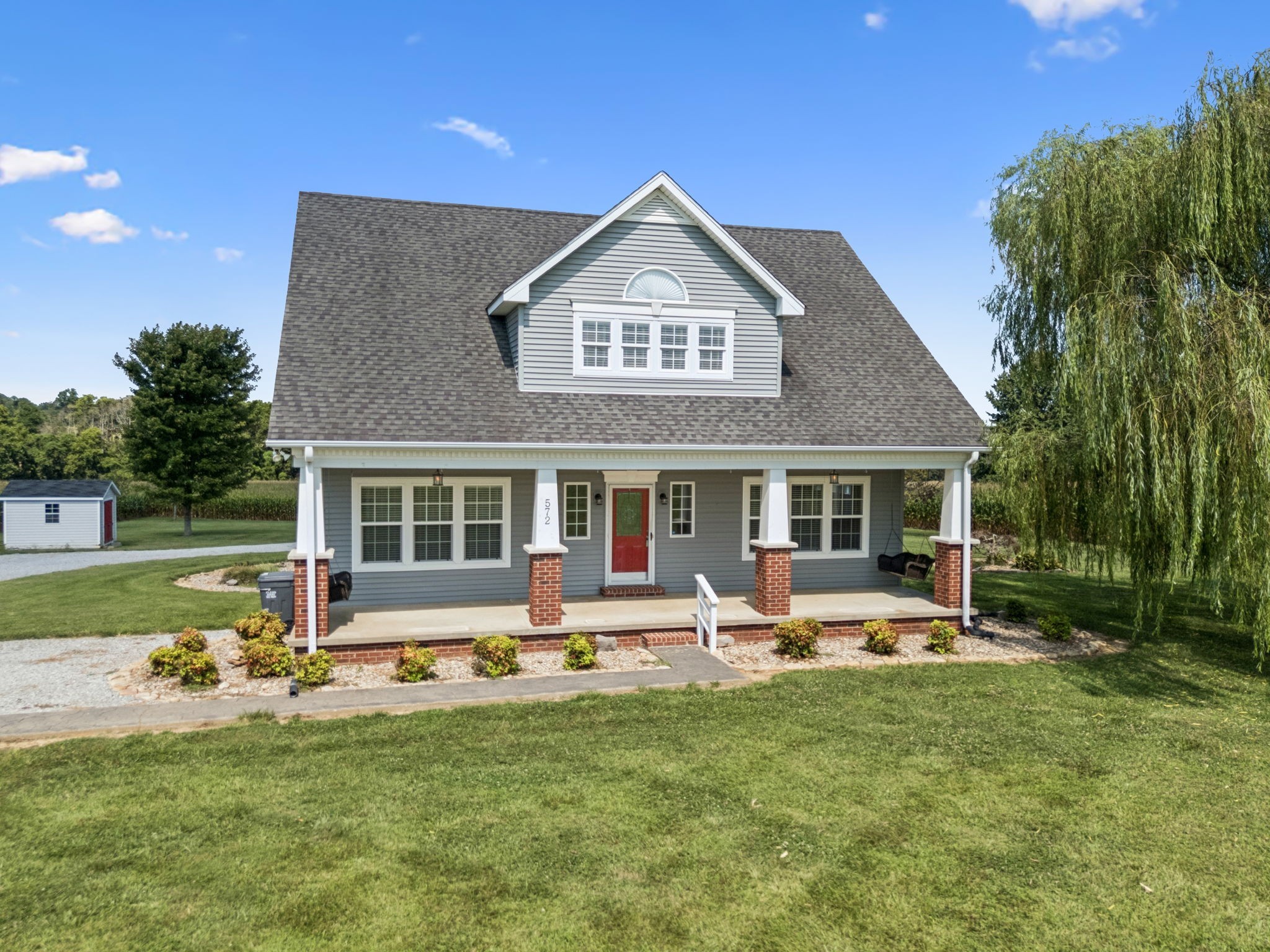 572 Buntin Mill Road Cottontown, TN 37048 - Photo 4 of 67 a front view of a house with garden and porch