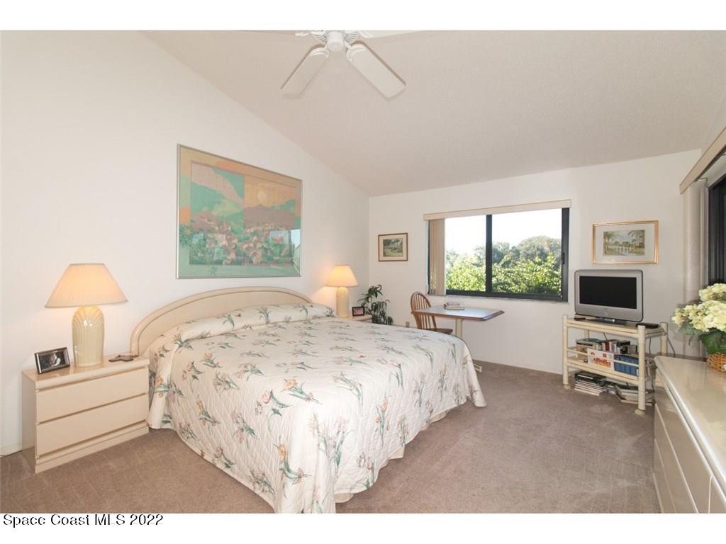 9640 Estuary Way, Unit 3 Sebastian, FL 32958 - Photo 12 of 24 a bedroom with a large bed and a window