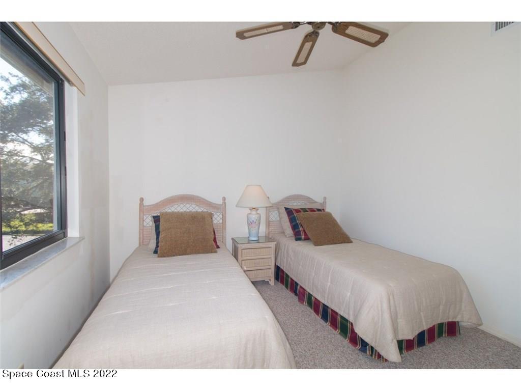 9640 Estuary Way, Unit 3 Sebastian, FL 32958 - Photo 4 of 24 a bedroom with two beds and a large window
