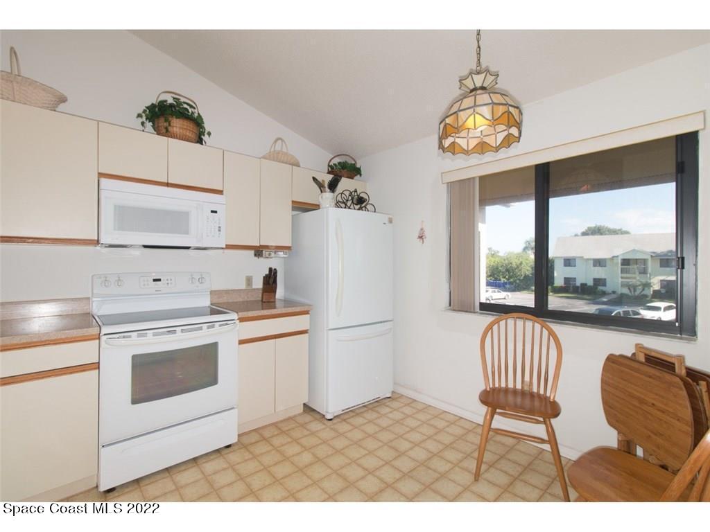 9640 Estuary Way, Unit 3 Sebastian, FL 32958 - Photo 8 of 24 a kitchen with a stove and a refrigerator
