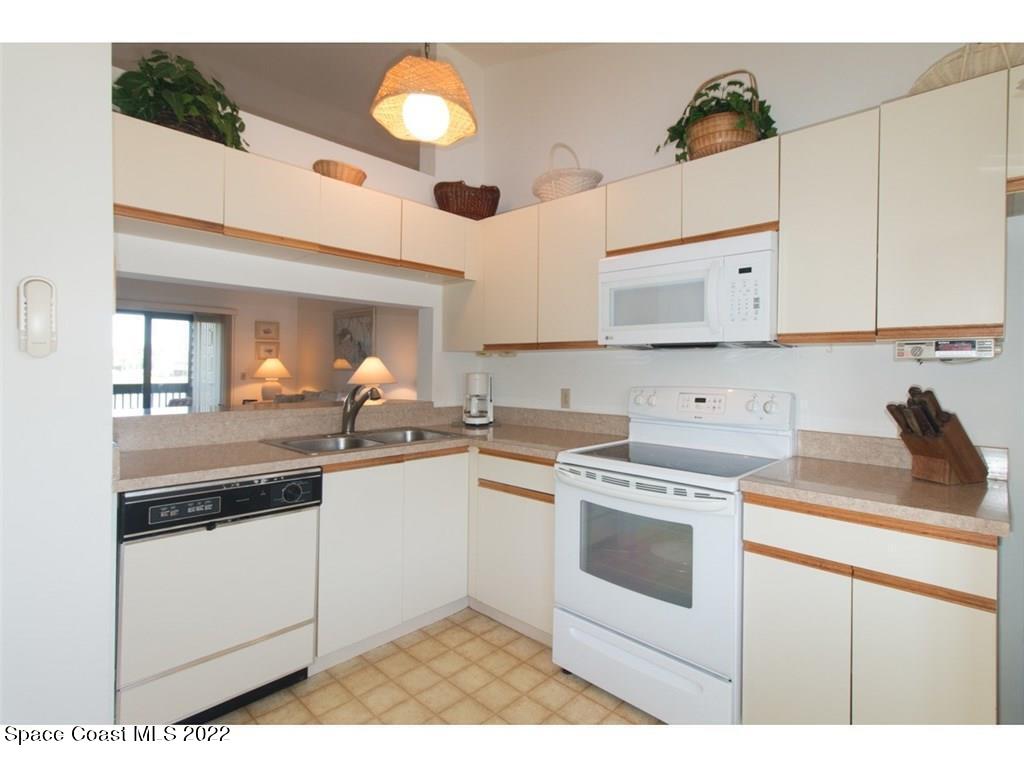 9640 Estuary Way, Unit 3 Sebastian, FL 32958 - Photo 9 of 24 a kitchen with a stove sink and cabinets