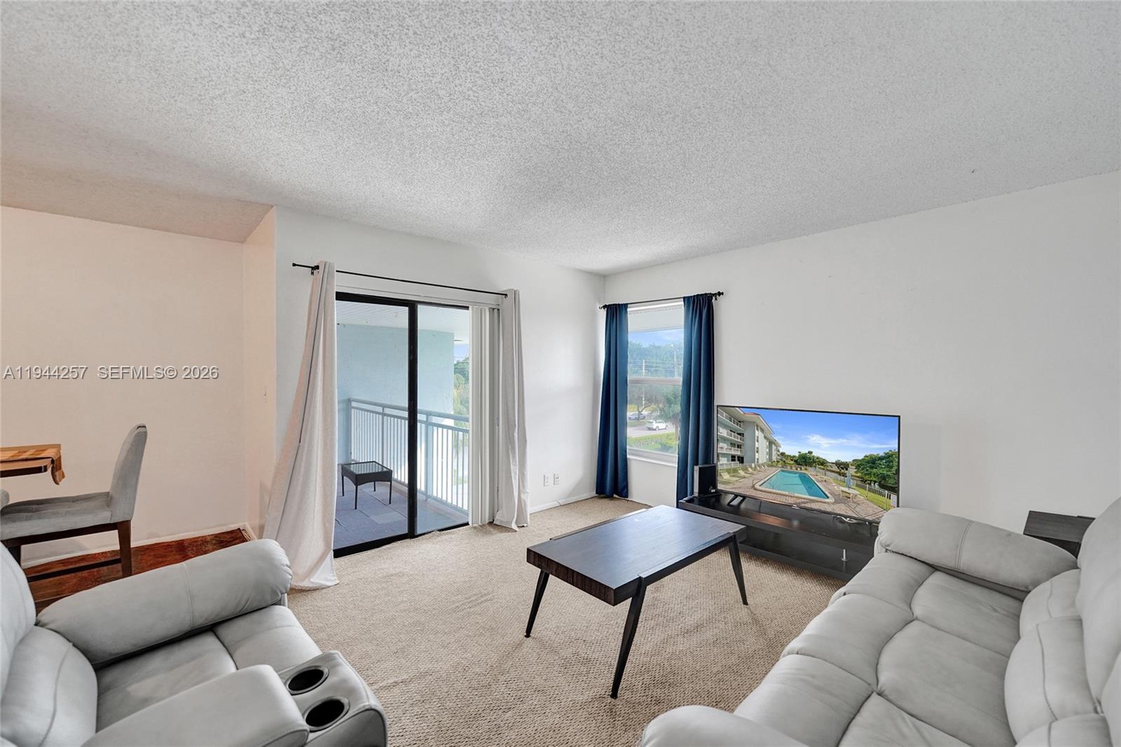 505 South Pine Island Road, Unit 405B Plantation, FL 33324 - Photo 12 of 43 a living room with furniture and a window
