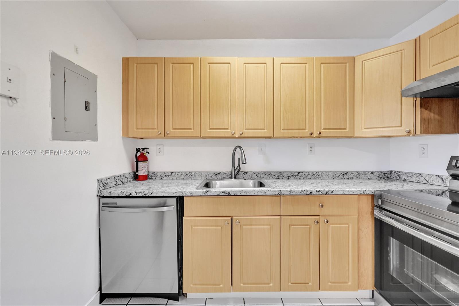 505 South Pine Island Road, Unit 405B Plantation, FL 33324 - Photo 16 of 43 a kitchen with granite countertop cabinets sink and stove
