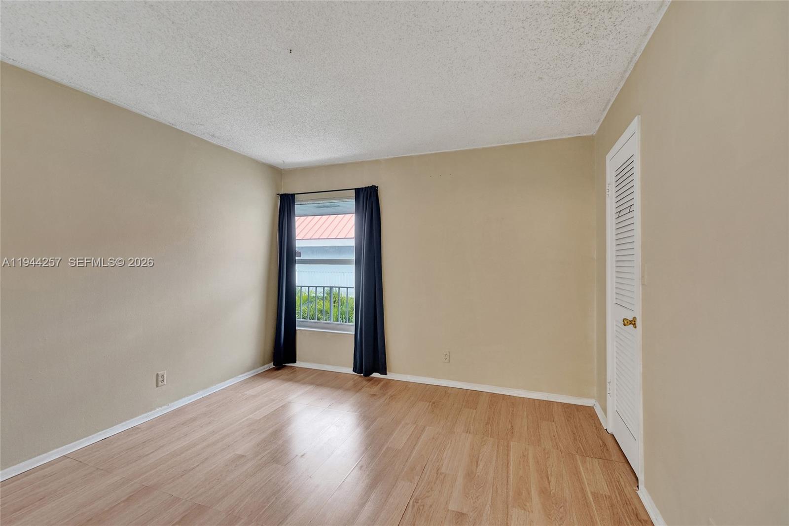 505 South Pine Island Road, Unit 405B Plantation, FL 33324 - Photo 22 of 43 an empty room with wooden floor and windows