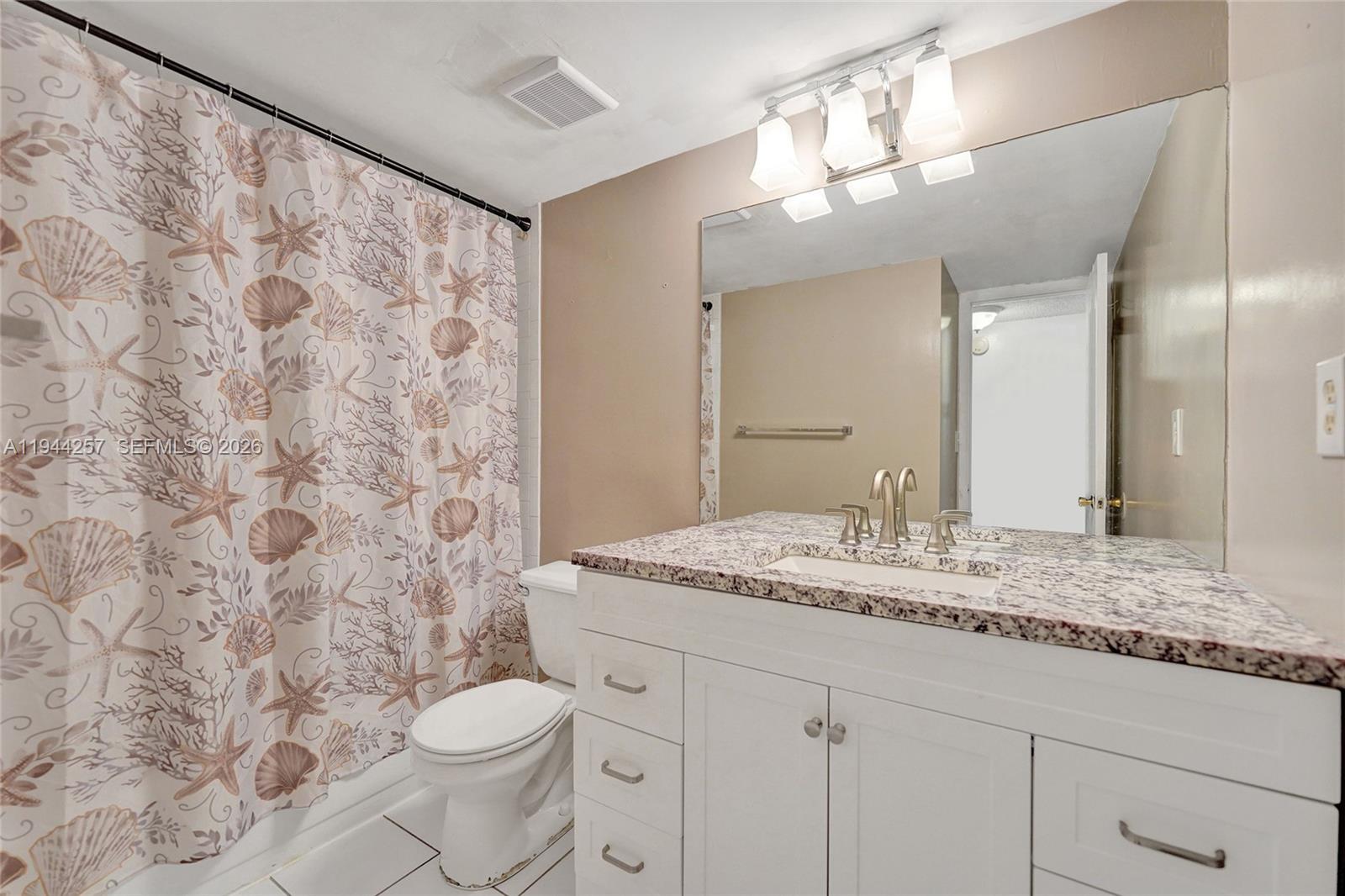 505 South Pine Island Road, Unit 405B Plantation, FL 33324 - Photo 23 of 43 a bathroom with a granite countertop sink a toilet and a mirror