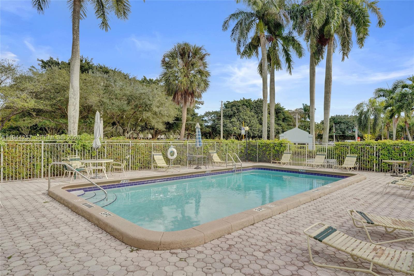 505 South Pine Island Road, Unit 405B Plantation, FL 33324 - Photo 33 of 43 a view of a swimming pool with a patio