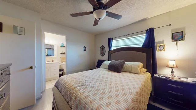 a bedroom with a bed and a lamp