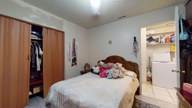 a bedroom with a bed and a window