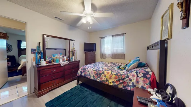 a bedroom with bed and wooden floor