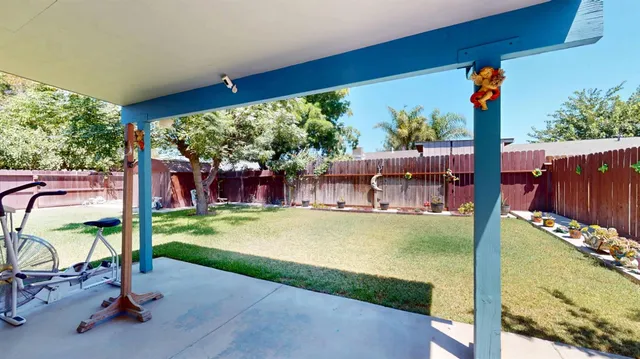 a backyard of a house with table and chairs