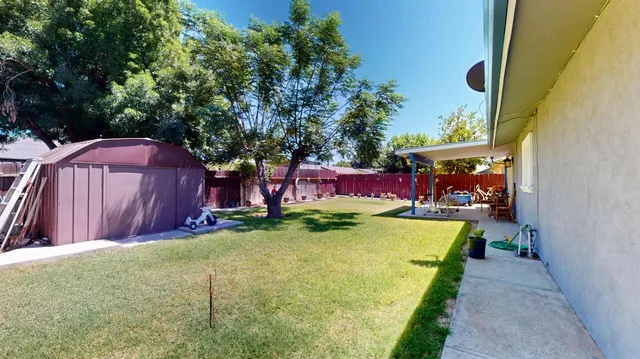 a view of a backyard with swimming pool