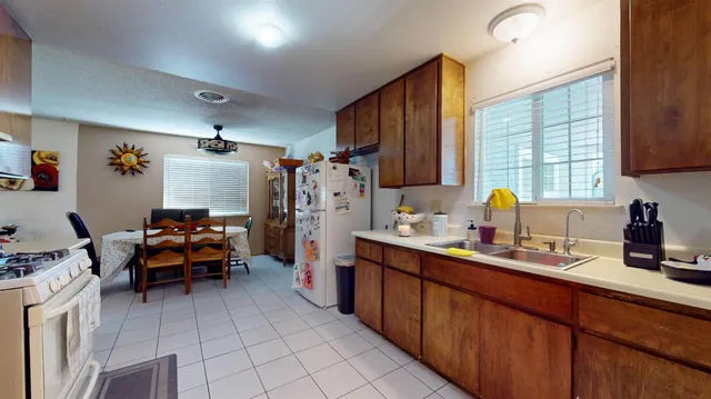 a kitchen with refrigerator and car parked