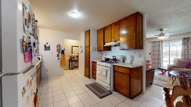 a kitchen that has a lot of cabinets in it and wooden floors