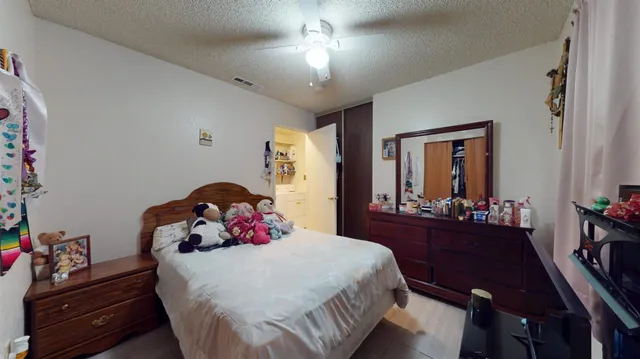 a bedroom with a bed and a dresser in it