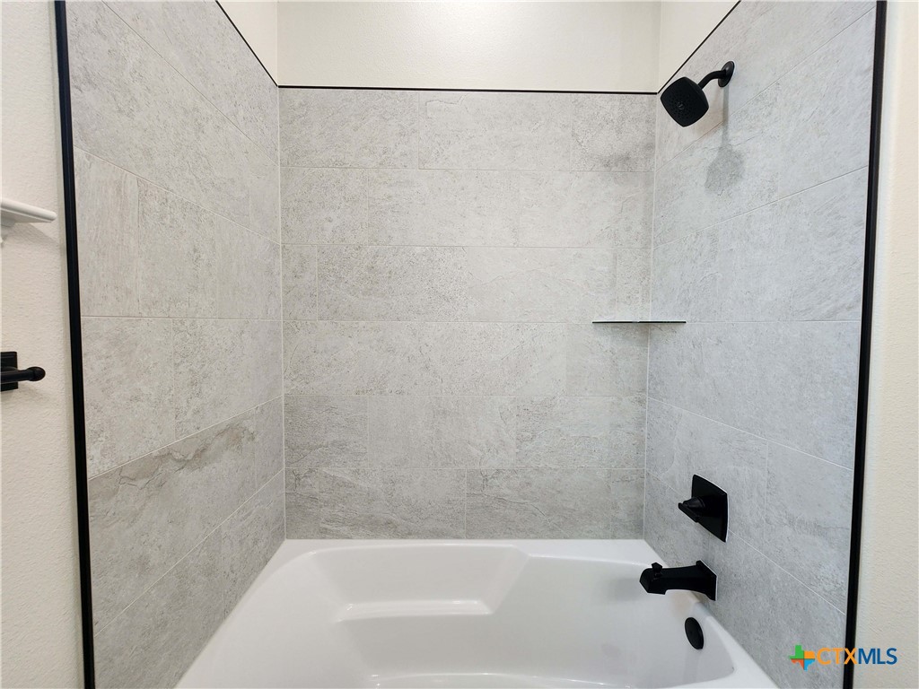 406 Talon Loop Salado, TX 76571 - Photo 15 of 31 a bathroom with a bathtub and shower