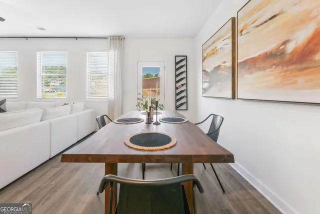 a dining room with furniture and wooden floor