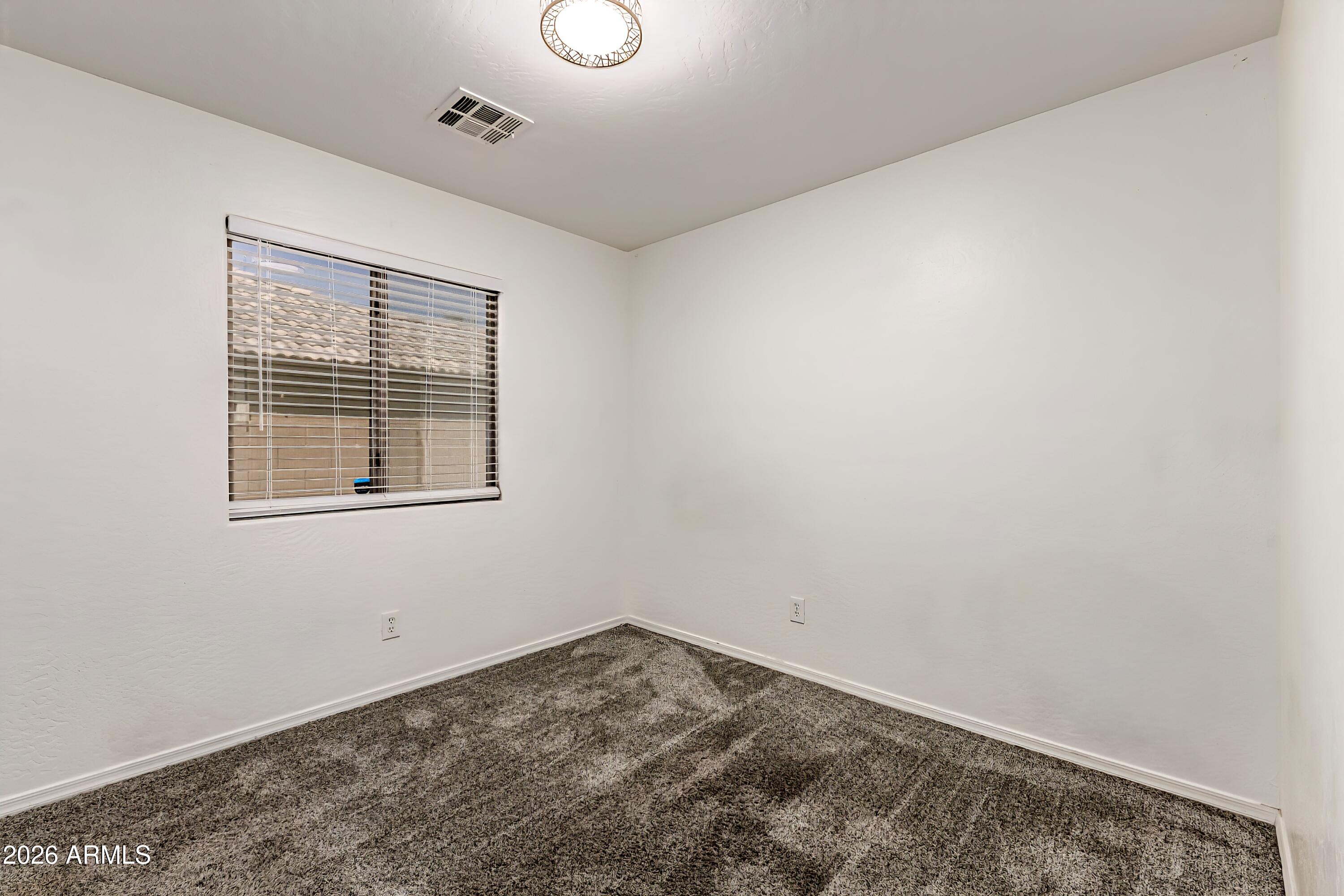 4208 South Sawmill Road Gilbert, AZ 85297 - Photo 38 of 46 an empty room with a window