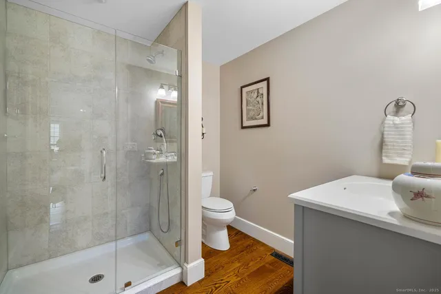 a bathroom with a sink a toilet and shower