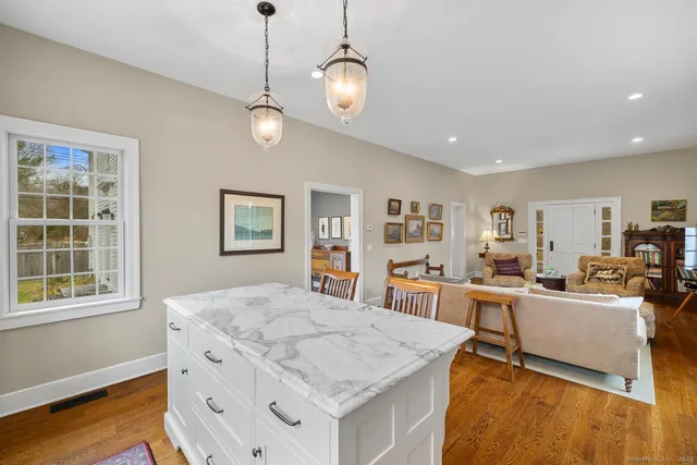 a view of a dining room with furniture a rug and wooden floor