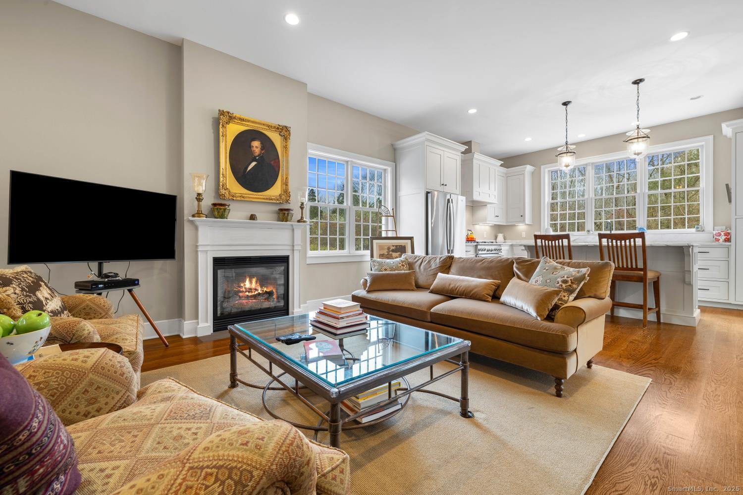 138 School House Road Old Saybrook, CT 06475 - Photo 28 of 40 a living room with furniture a flat screen tv and a fireplace