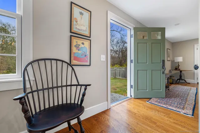 a view of a hallway with wooden floor and windows