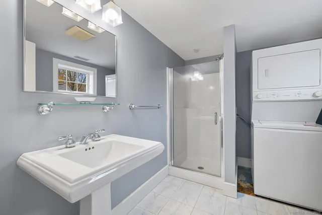a white bath tub sitting next to a bathroom sink