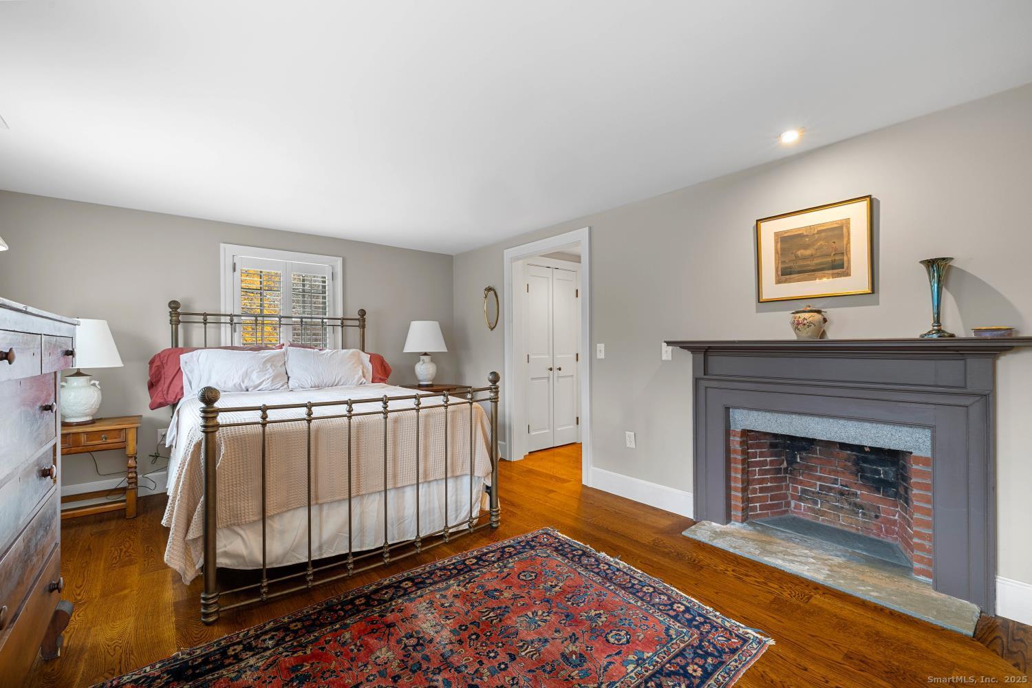 138 School House Road Old Saybrook, CT 06475 - Photo 35 of 40 a bedroom with a bed and a fireplace
